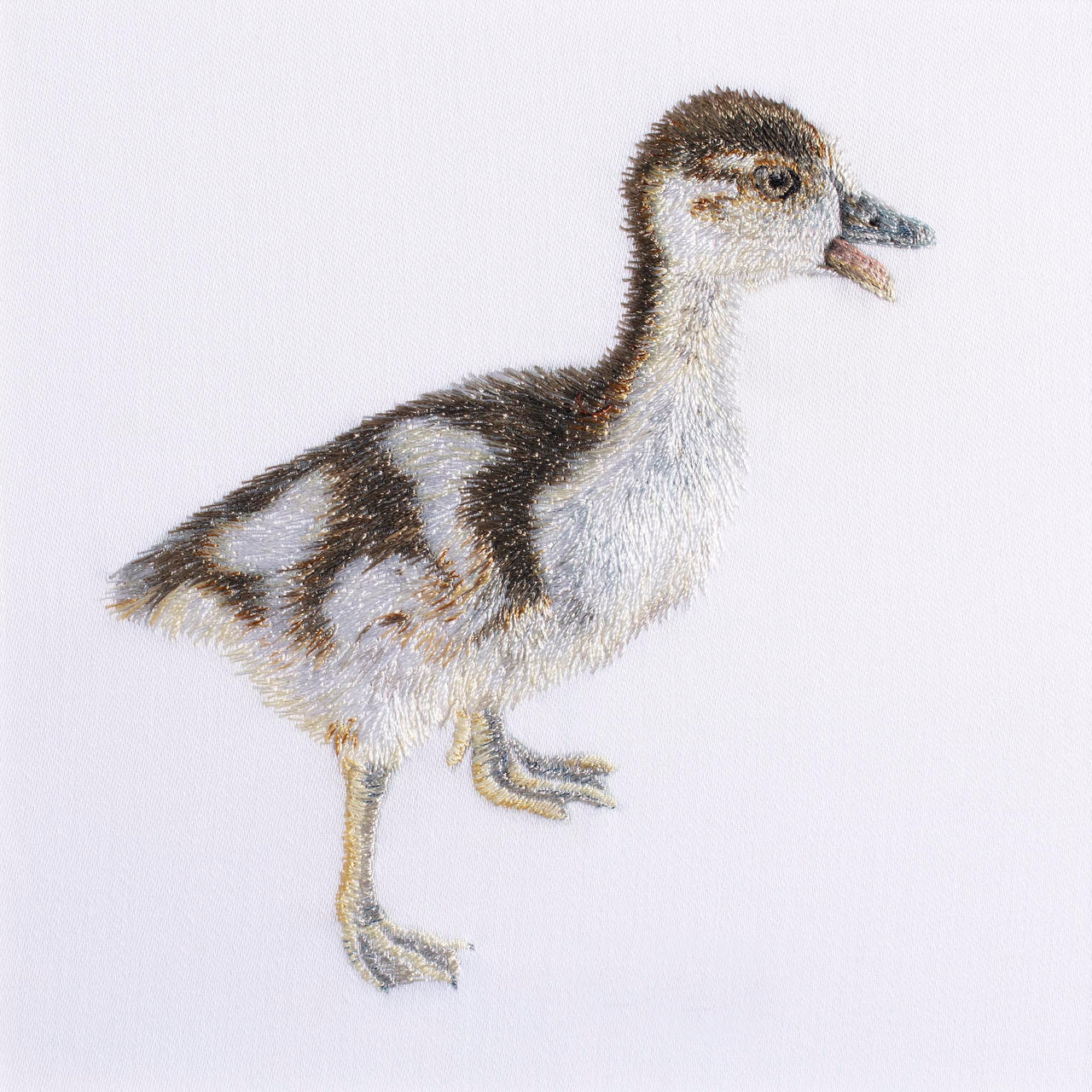 Hand embroidered gosling artwork.