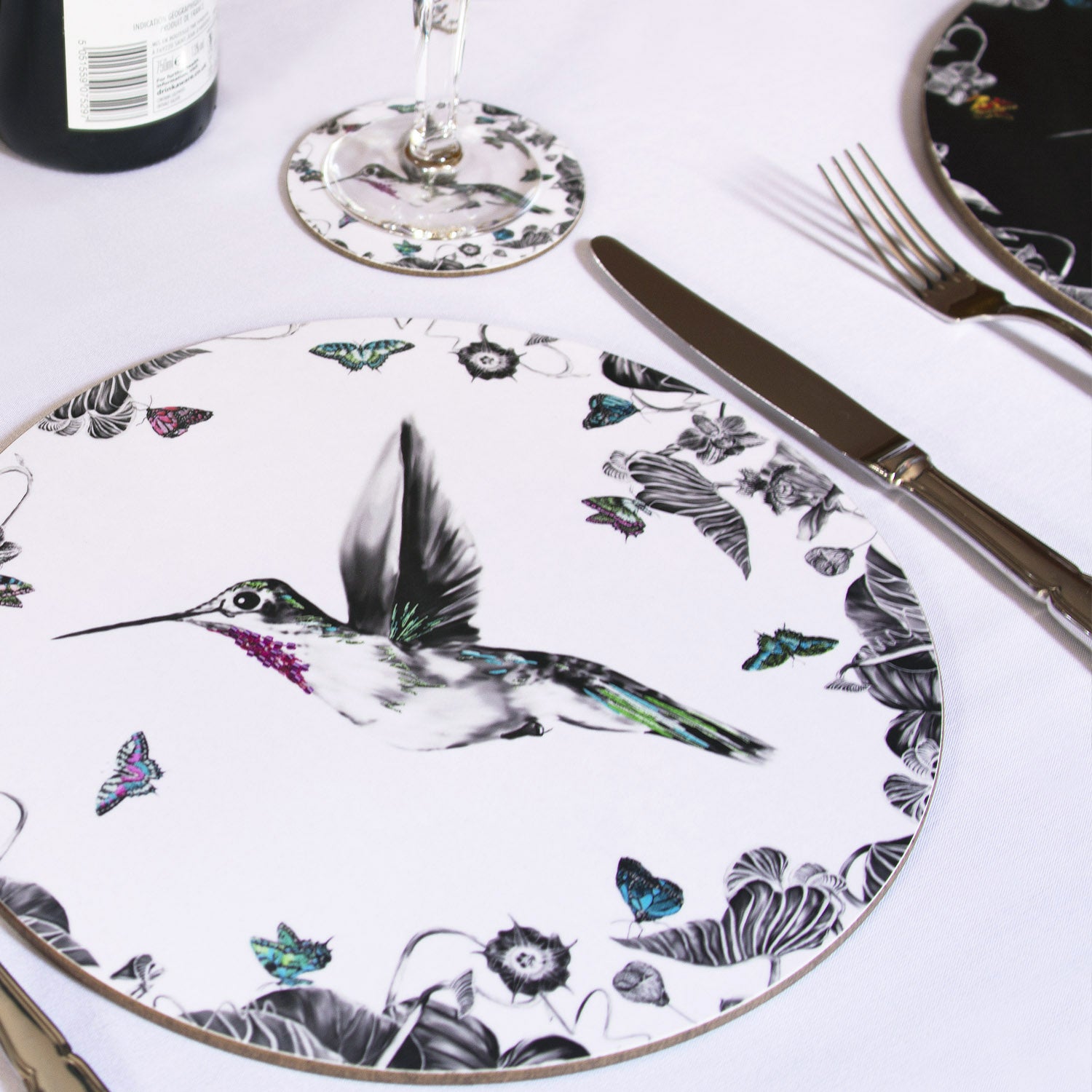 White hummingbird placemat on the table.